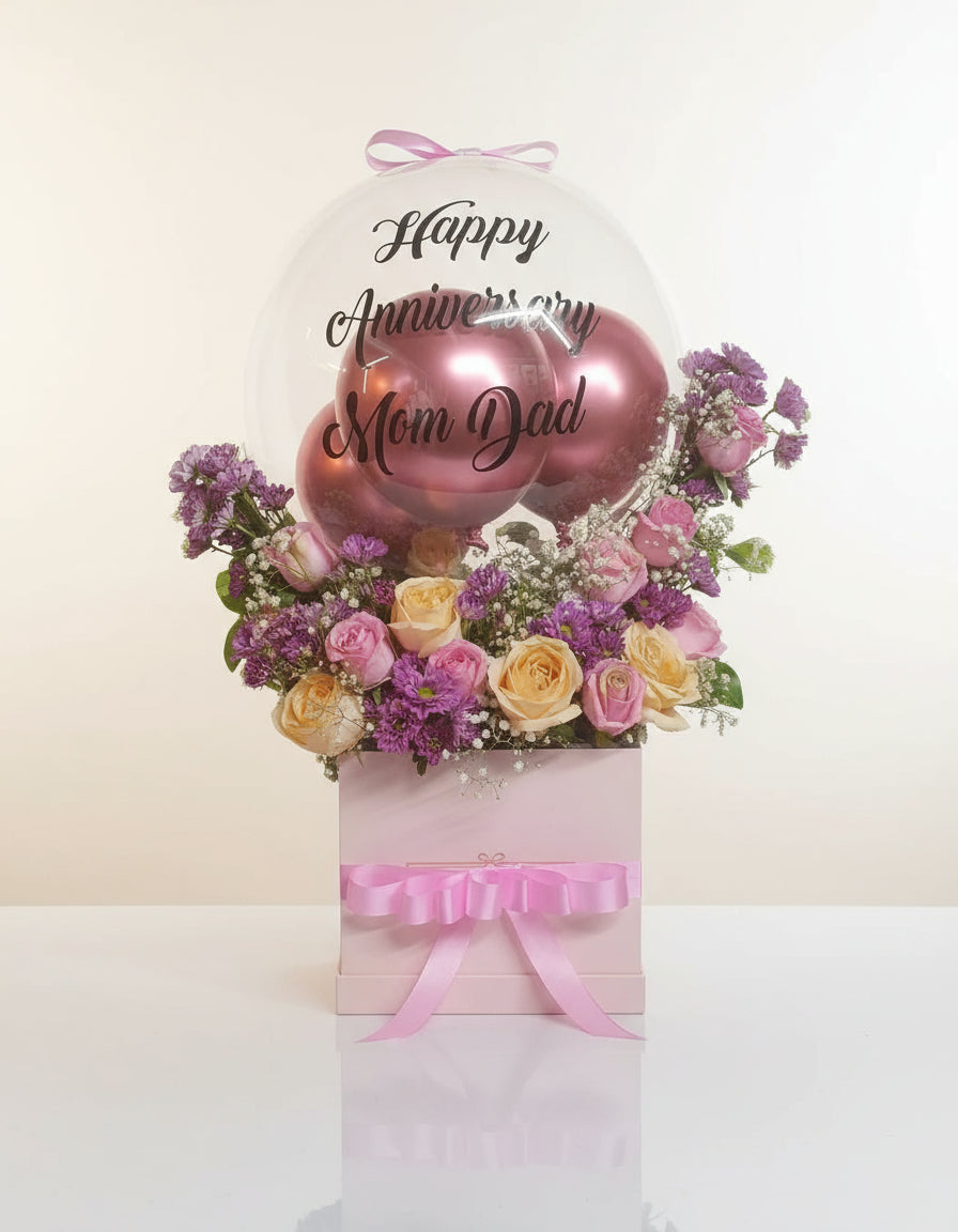Send the perfect birthday surprise with a beautiful gift box of yellow-pink roses, purple daisies, and stylish "Happy Birthday" balloons. A delightful combination to brighten someone's special day.