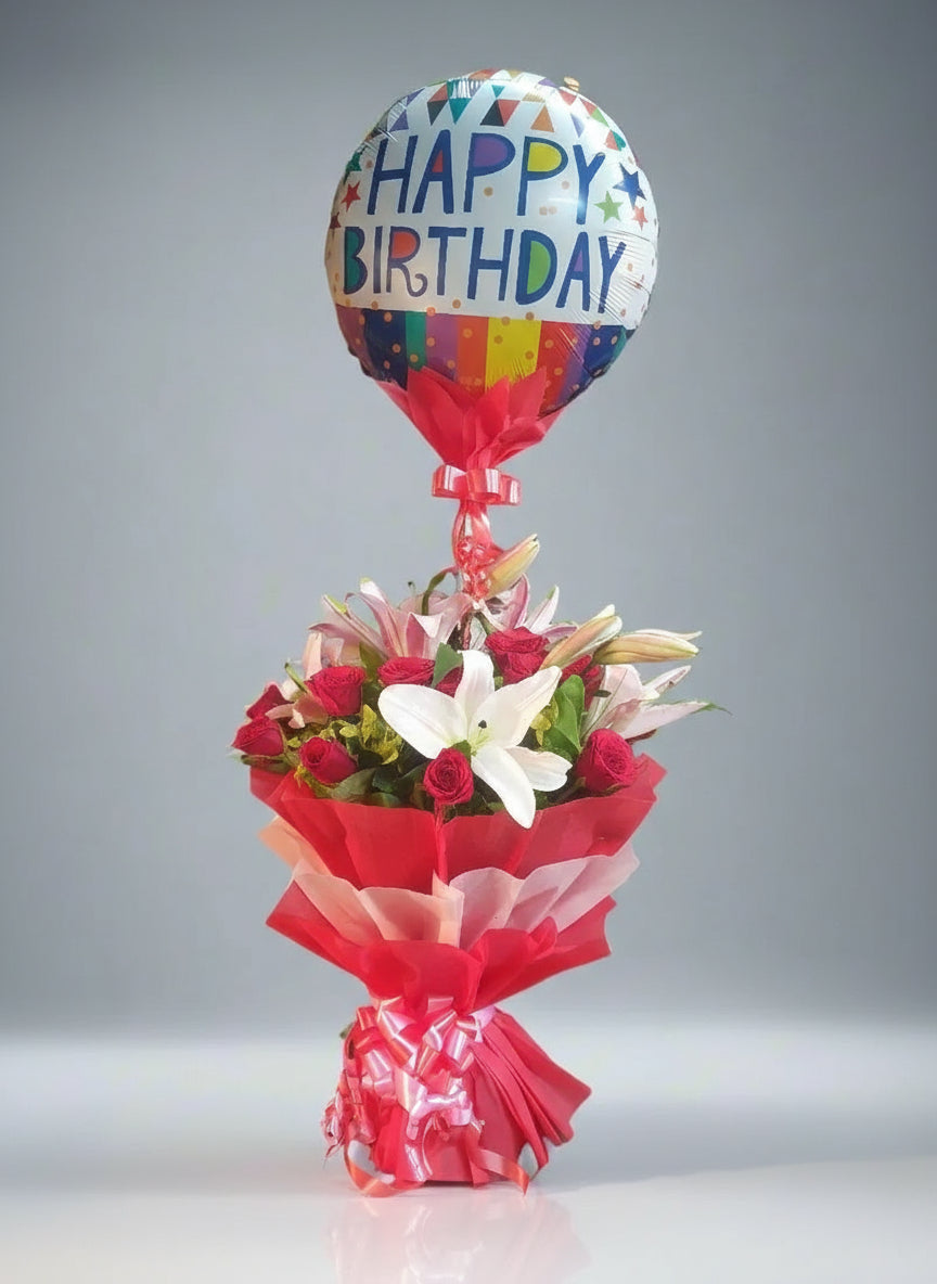 Celebrate joy and elegance with a standing balloon bouquet featuring pink lilies, red roses, and white lilies. Perfect for any occasion, this stunning floral arrangement brings style and happiness together.