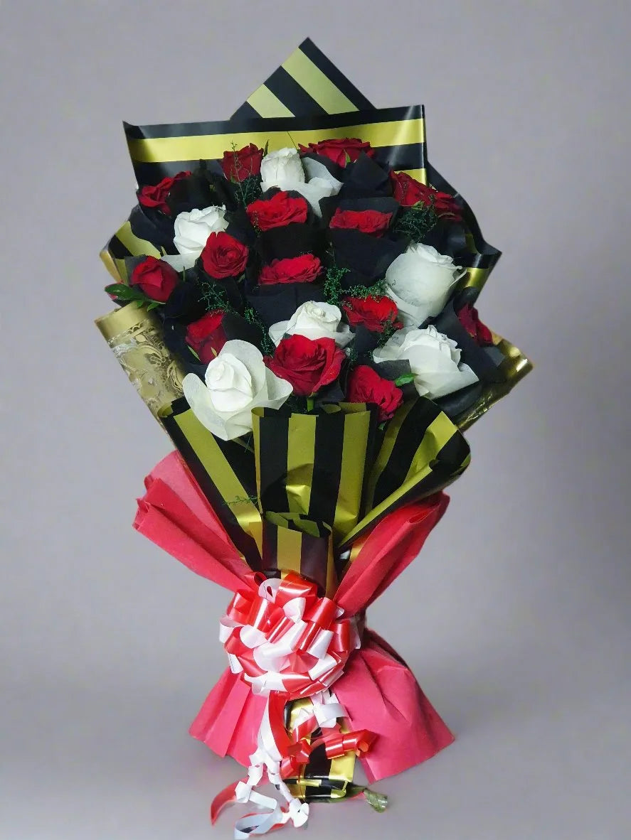 Discover a breathtaking bouquet of red and white roses wrapped in dark green and white paper—perfect for gifting with elegance and love.