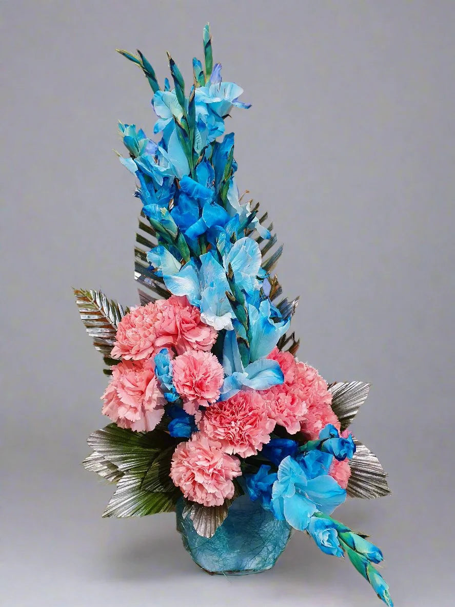Elegant floral arrangement with soft pink carnation roses and vibrant sky blue gladiolus, exuding sophistication and charm. Perfect for any occasion.