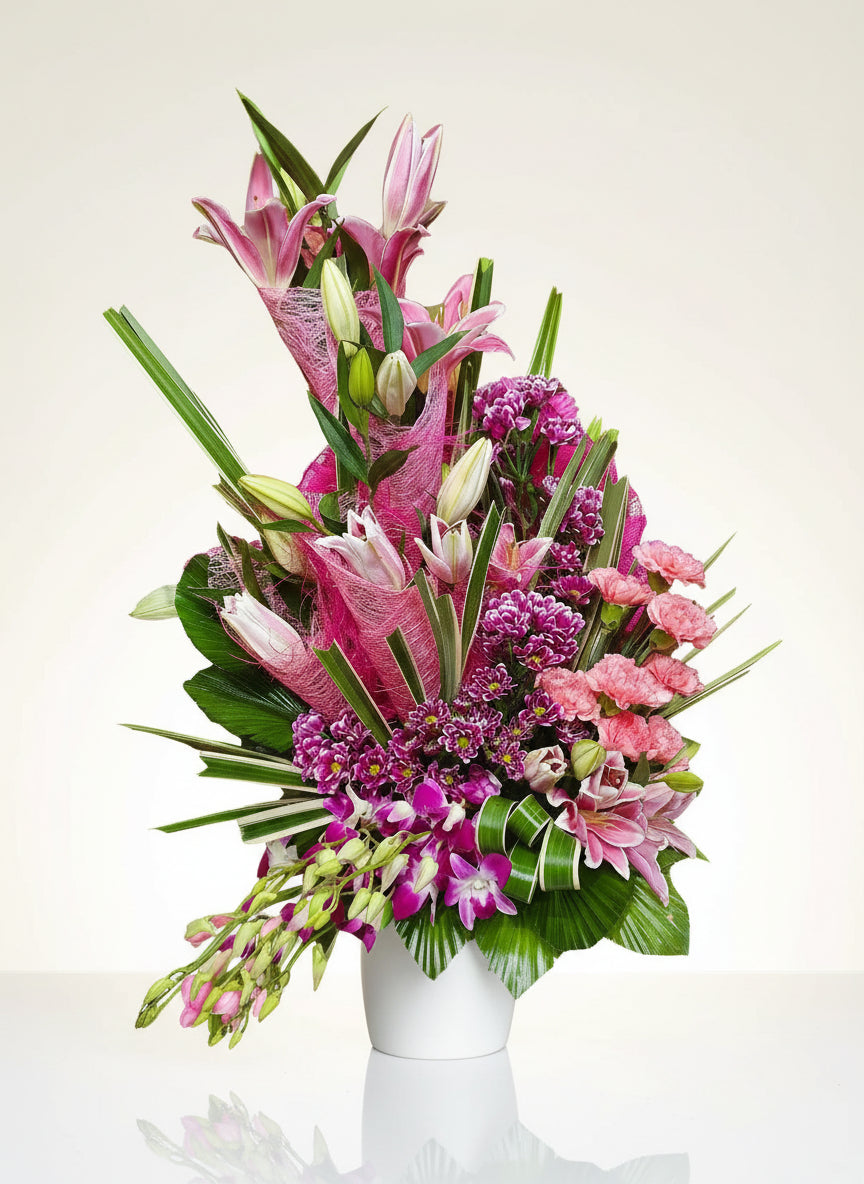 A serene blend of pink carnations and white lilies, symbolizing love and purity. Perfect for weddings, gifts, or special occasions.