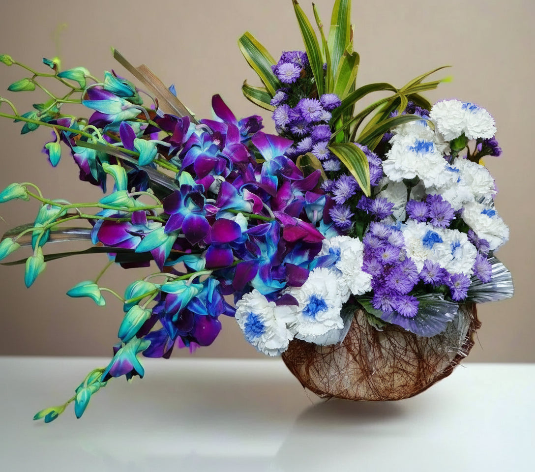 Dark purple roses and white-purple carnations with lush green leaves in a stylish pot. A perfect blend of elegance and sophistication.