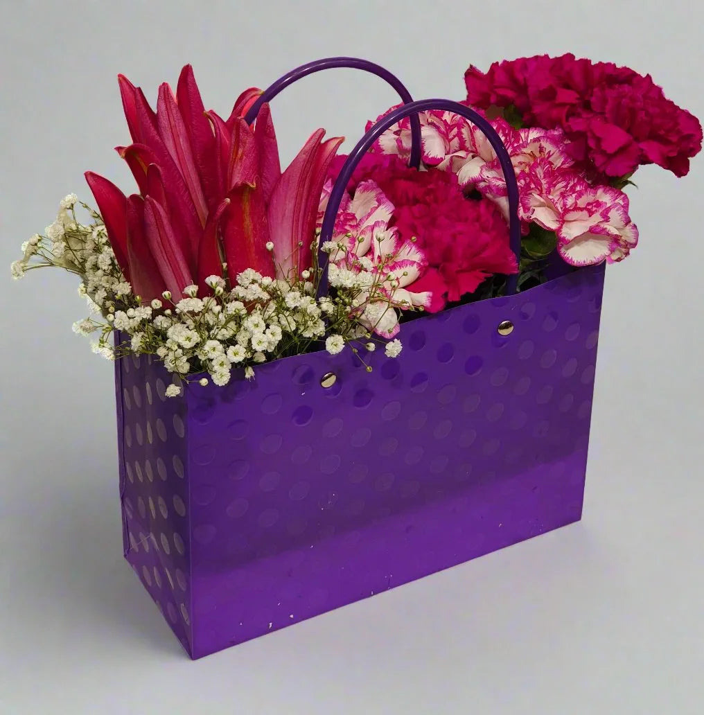Elegant floral arrangement featuring vibrant pink carnations and lilies, perfect for adding charm to any occasion. Fresh, beautiful, and lasting.