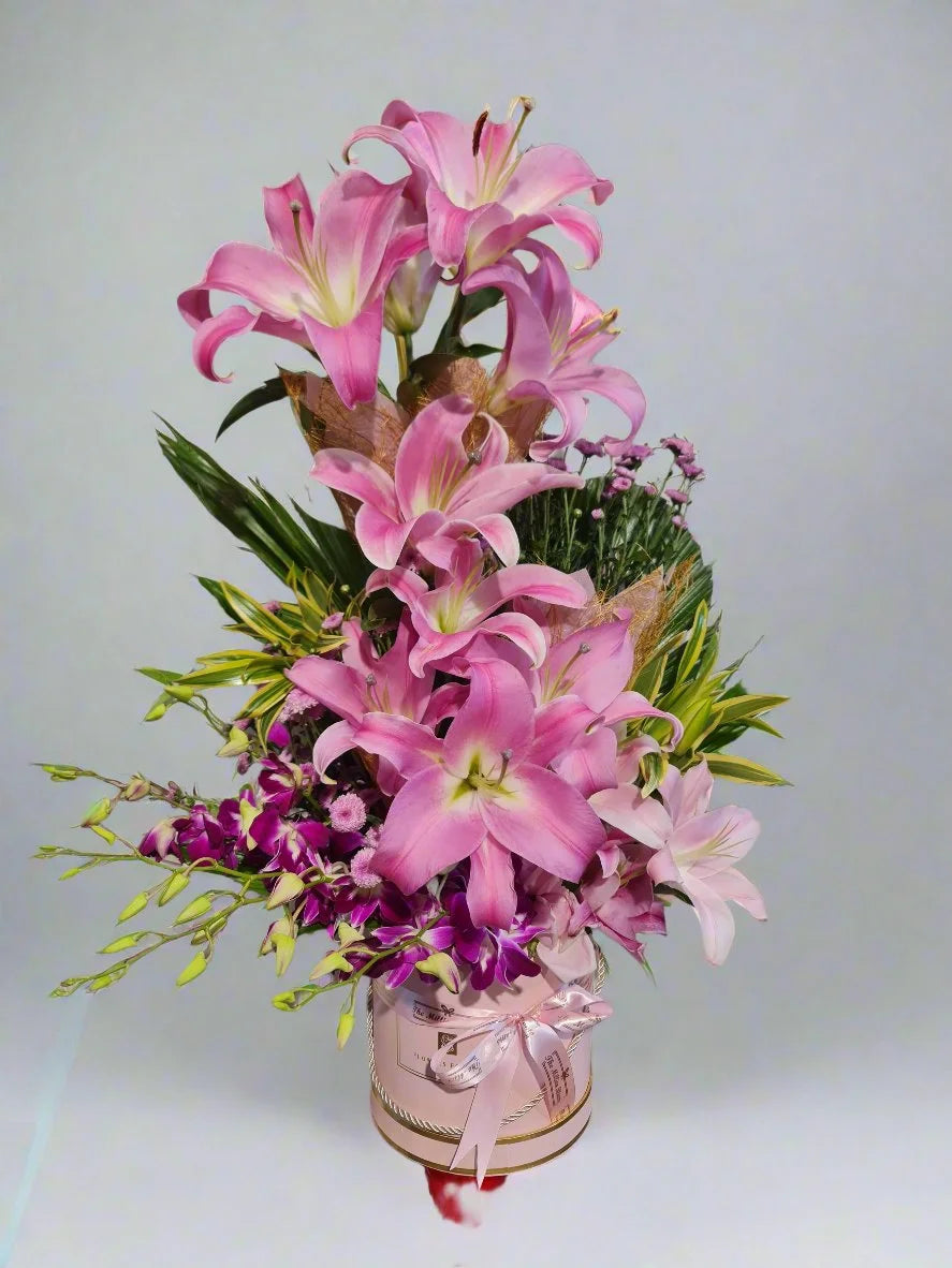 Discover a stunning bouquet of vibrant pink lilies and delicate pink orchids, perfect for any occasion. Elegance meets timeless beauty!