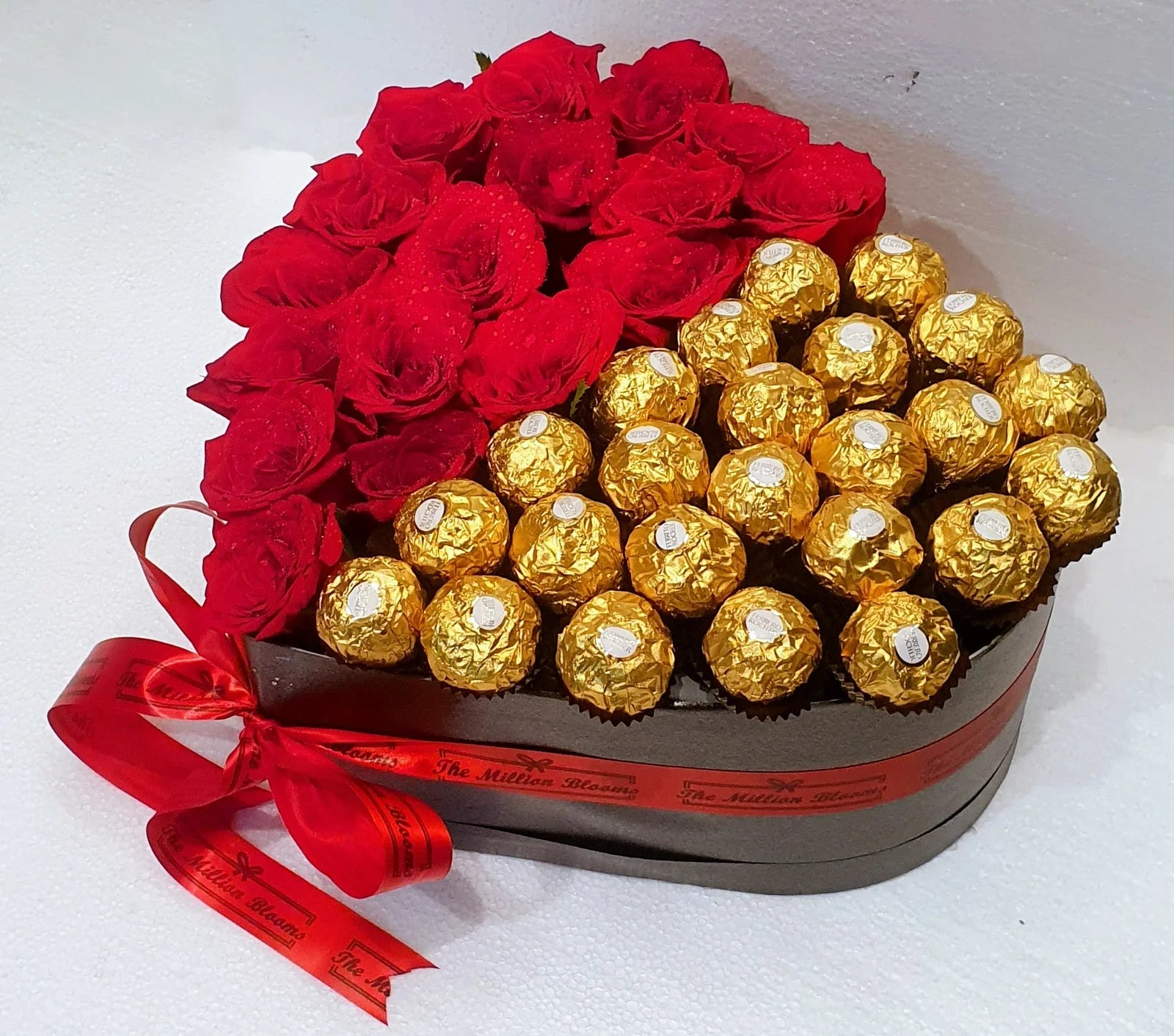Surprise loved ones with red roses, Ferrero Rocher chocolates, and a stunning black heart-shaped box. Perfect gift for any occasion!
