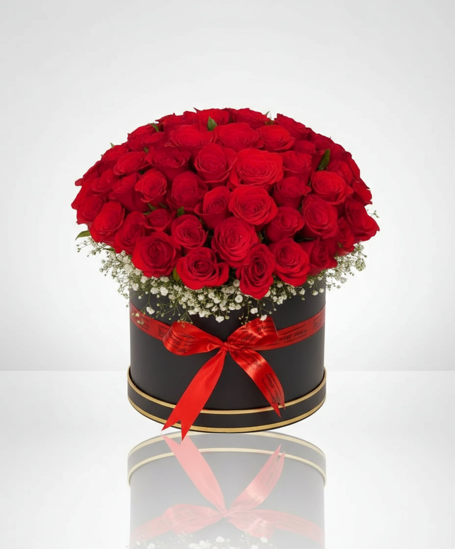 Luxurious red roses with white fillers in a chic black box. Perfect for expressing love and admiration. Order now for an unforgettable gift!